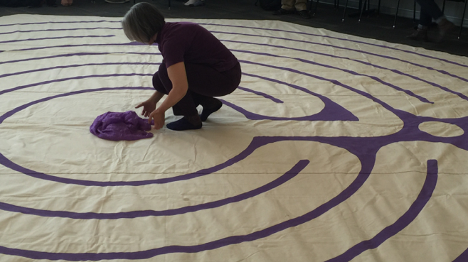 Woman arranging cloth at the center of a labyrinth