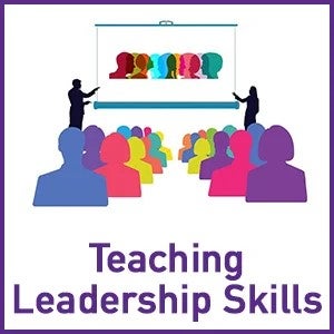 Teaching Leadership Skills - two presenters in front of a large crowd